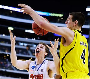 Michigan's Mitch McGary knocks the ball away from Florida's Erik Murphy. McGary has averaged 17.5 points and 11.5 rebounds per game for the Wolverines in the NCAA tournament.