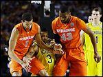  Syracuse's Michael Carter-Williams (1) and James Southerland (43) vie for a loose ball Michigan's Trey Burke during the first half.