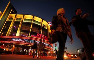 People walk in front of the Regal Cinemas LA Live Stadium 14 in Los Angeles, California, on February 14, 2013. Movie theater chains are putting pressure on studios to pay more to have their trailers placed in front of the audiences they want. 