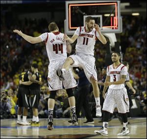 Louisville's Luke Hancock (11) Louisville's Peyton Siva (3) and Louisville's Stephan Van Treese celebrate their win against Wichita State tonight in Atlanta.