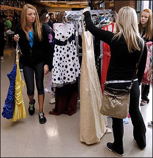 Swanton eighth grader Sarah Yaney, left, shops for a formal dress with her friends during the prom dress sale at Owens Community College in Perrysburg Township.