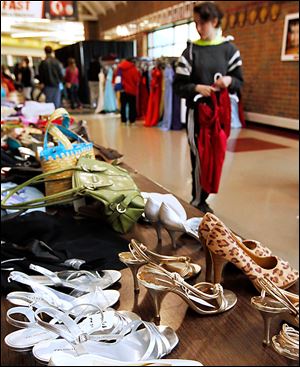Shoes and purses also are lined up for purchase at the prom dress sale organized by the Owens Raising Awareness Club and Springfield High School Academic Boosters