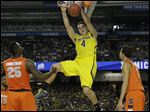  Michigan's Mitch McGary dunks the ball against Syracuse during the second half of the national semifinal on Saturday. McGary has been the Wolverines' leading scorer and rebounder during their postseason run.