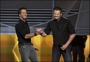 Luke Bryan, left, and Blake Shelton speak on stage at the 48th Annual Academy of Country Music Awards on Sunday at the MGM Grand Garden Arena in Las Vegas.