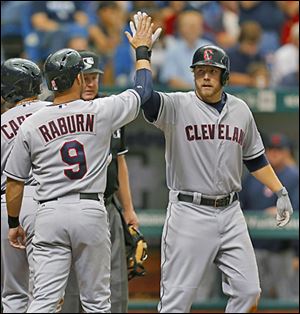 The Indians' Mark Reynolds, right, is congratulated after his three-run home run by teammate Ryan Raburn.