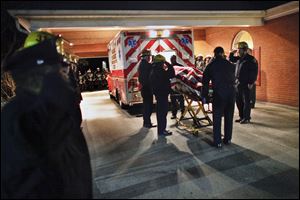 Fellow firefighters salute the body of fallen comrade Capt. Michael Goodwin at a funeral home in Philadelphia, early today.