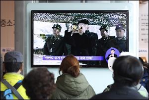 People watch a TV program showing North Korean leader Kim Jong Un at Seoul Railway Station in Seoul, South Korea, today.