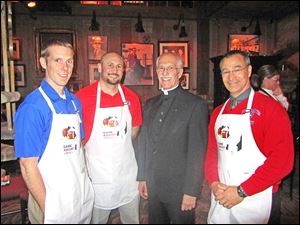Father Ron Olszewski, right center, stands with St. Francis de Sales athletic coaches and event wait staff Jim Neary, Brandon Kulka, and Bill Toney.