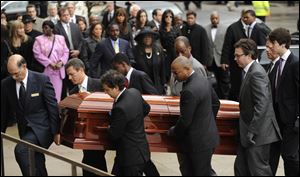 Pallbearers carry the casket of film critic Roger Ebert before his funeral at Holy Name Cathedral in Chicago.