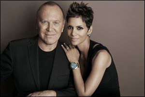 Michael Kors and actress Halle Berry pose for a photo at Kors' Midtown office in New York. Kors and Berry have announced a partnership with the U.N. World Food Programme to raise money and awareness to tackle the issue of world hunger.
