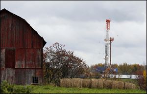 A drilling rig is set up near a barn in Springville, Pa., to tap gas from the giant Marcellus Shale gas field. A new plan to strengthen standards for fracking is creating unusual divisions among environmentalists and supporters for the oil and gas industry. Some environmentalists say the new partnership between the gas companies and environmentalists is too soft. Others in the industry complain the program, announced March 20, goes too far.