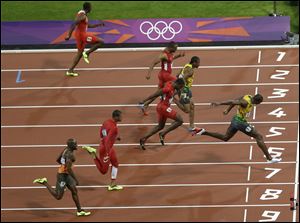 Jamaica's Usain Bolt, right, crosses the finish line to win the men's 100-meter final race during the athletics competition in the Olympic Stadium at the 2012 Summer Olympics, London, last August.