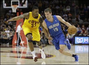 Orlando Magic's Beno Udrih (19), from Slovenia, drives past Cleveland Cavaliers' Alonzo Gee (33) during the first quarter Sunday night.