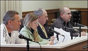 Rossford Council members, from left, Greg Marquette, Caroline Eckel, Larry Oberdorf, and Jerry Staczek attend a meeting where an ordinance to ask voters for a raise received its first reading.