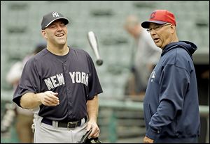 Yankees third baseman Kevin Youkilis talks with Indians manager Terry Francona, who was Youkilis' manager in Boston.