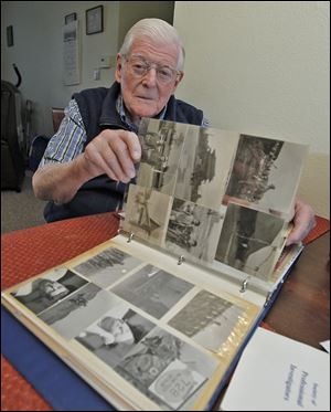 Korean War veteran Gene Meyer reviews his photo album inside his West Park Place apartment in Toledo as he shares his concern with the events and threats of war from the new North Korean leader.