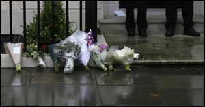 Floral tributes are seen outside former British Prime Minister Baroness Thatcher's home in London Tuesday.