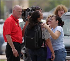Lone Star College student Michelle Alvarez, second from right, is examined by her aunt Elena Tokarew, right,  after the stabbings at Lone Star College's Cypress-Fairbanks campus today. 