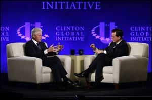 Former President Bill Clinton, left, and Comedy Central's Stephen Colbert during the Clinton Global Initiative at Washington University in St. Louis, Saturday.