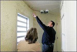 Sheriff’s Lt. Dave Friddell shows water damage at the  Lucas County jail to Carol Contrada, president of the county commissioners. 