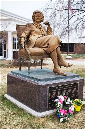 Flowers honor former British Prime Minister Margaret Thatcher at her statue at Hillsdale College after her death this week. The 'Iron Lady' was 87.