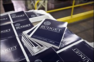 Copies of President Obama's budget plan for fiscal year 2014 are prepared for delivery at the U.S. Government Printing Office in Washington Monday.