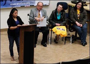 Columbus resident Maria Sanchez talks of unfairness in the work-place during a statewide meeting at the University of Toledo.