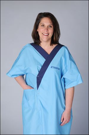 A model wears the new patient gown  developed by the Henry Ford Innovation Institute in collaboration with the College for Creative Studies in Detroit. The somewhat more stylish gown is made of a cotton-polyester blend that is thicker than typically used; has three snaps instead of ties; is accessible for IVs, and closes in the backside — which was the “No. 1 goal,” a designer said.  