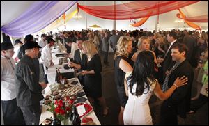 Partygoers sample foods during last year's Taste of the Nation at the Toledo Club.