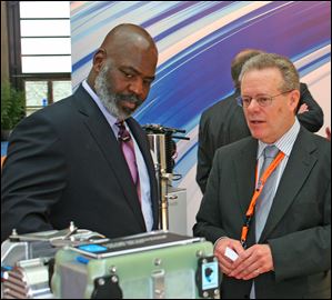 In between meetings at Hannover Messe, in Germany, Mayor Mike Bell stops to talk with Dana excutives. Brian Cheadle, director of global business development, shows the mayor fuel cell technology, including its newly announced Metallic Bipolar Plates.