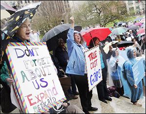 Demonstrators support a Medicaid expansion outside the Ohio Statehouse in a rally urging state lawmakers to extend Medicaid coverage under the federal health care law. Ohio House Republicans cut the expansion from the budget.