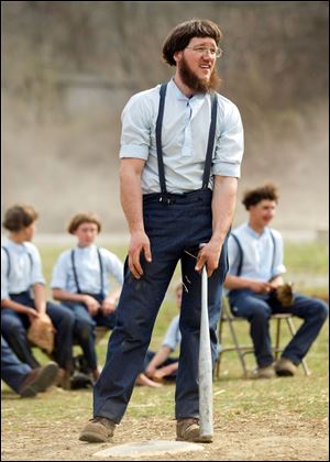 Freeman Burkholder waits for his at bat during a game of baseball at the farewell picnic April 9 in Bergholz, Ohio. The picnic was for Burkholder and other Amish people leaving for prison this week for their part in the hair and beard cutting scandal against other Amish members.