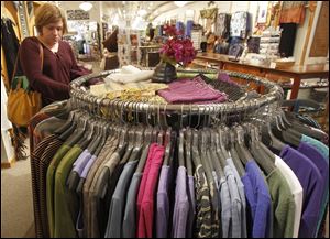 In this Tuesday, April 9, 2013 photo, a shopper looks over the clothes at the Vermont Trading Company in Montpelier, Vt. 