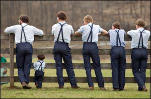 Amish boys watch a game of baseball outside the school house April 9 in Bergholz, Ohio. Many Amish families gathered following the final day of school for a celebration and farewell picnic.