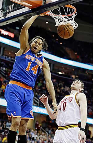 The Knicks' Chris Copeland (14) dunks over the Cavaliers' Tyler Zeller.