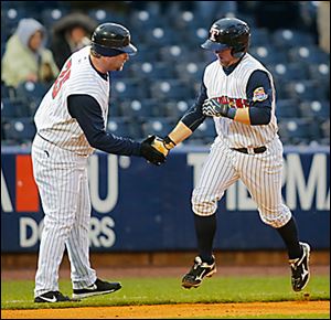 Mud Hens manager Phil Nevin, left, congratulates Bryan Holaday after he hit a home run.