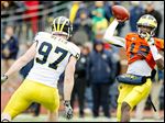  Michigan quarterback Devin Gardner throws the ball against defensive end Brennen Beyer during the spring game Saturday in Ann Arbor.
