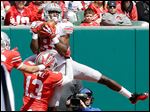  OSU's Michael Thomas makes a catch against Eli Apple. Thomas finished with seven catches for 79 yards for the Grey squad.