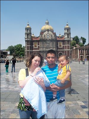 The Perez family visits the Basilica in Mexico City. The only way Elizabeth Perez and the children can now visit Marcos Perez, center, is by traveling to Mexico.