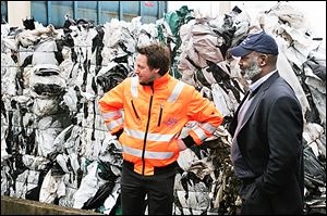 Sebastian Koch, left, shows Mayor Mike Bell bales of plastics that will be recycled at the city-owned waste management facility in Delmenhorst, Germany. 