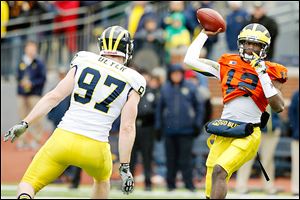 Michigan quarterback Devin Gardner throws the ball against defensive end Brennen Beyer during the spring game Saturday in Ann Arbor.