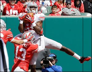 OSU's Michael Thomas makes a catch against Eli Apple. Thomas finished with seven catches for 79 yards for the Grey squad.