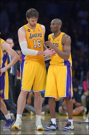 Los Angeles Lakers guard Kobe Bryant, right, is helped off the court by forward Pau Gasoll after being injured Friday night in Los Angeles.