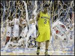  Michigan guard Trey Burke (3) walks off the court as Louisville celebrate their win during the second half of the NCAA Final Four tournament college basketball championship game Monday, April 8, 2013, in Atlanta. Louisville won 82-76. Burke announced today he is foregoing his senior year to declare for the NBA draft.