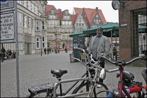 Mayor Mike Bell pauses in the marketplace in Bremen, Germany, on Sunday. Toledo officials are set to talk about the Glass City at Delmenhorst City Hall today. 