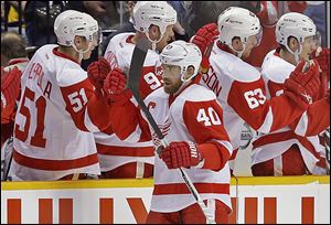 The Red Wings' Henrik Zetterberg (40) is congratulated by Valtteri Filppula (51) after scoring against Nashville in the second period on Sunday.