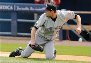 Louisville Bats pitcher Tony Cingrani drops the ball after fielding a bunt by Mud Hens center fielder Quintin Berry during the first inning.