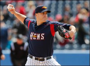 Mud Hens starting pitcher Shawn Hill fires a pitch during the first inning. The 31-year-old right-hander held Louisville in check for seven innings, limiting the Bats to five hits and two runs but taking a hard-luck loss.