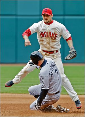 The Indians’ Ryan Raburn avoids the White Sox's Jeff Keppinger after a throw to first to complete a double play on Alex Rios.