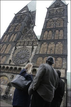 Mayor Mike Bell and Christa Luttman, a Toledoan with ties to Germany, gaze at the 13th-century St. Peter Cathedral in Bremen, Germany.